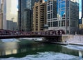 Chicago River is frozen and reflecting bridge over it on frigid winter afternoon. Royalty Free Stock Photo