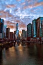Chicago River reflections after a winter storm as clouds clear and sun begins to set.