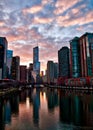 Chicago River stunningly reflects cityscape after a winter storm as clouds clear and sun begins to set. Royalty Free Stock Photo