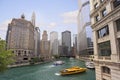 Chicago River with water taxi and boats sailing between the beautiful skyscrapers skyline