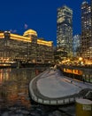 Chicago riverwalk through city night lights illuminated onto a frozen Chicago River. Royalty Free Stock Photo