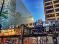 Chicago`s el train passes through the city at midday