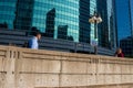 Chicago`s upper Wacker Drive, where pedestrians walk along a wall etched with III, commemorating the 3 forks of the Chicago River