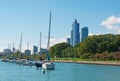 Chicago skyline with sailboats and speedboats in the park district, dock and pier of Michigan Lake shoreline