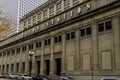 The Chicago Union Station building surrounded by cars parked along the street, skyscrapers and office buildings