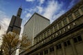 The Chicago Union Station building surrounded by skyscrapers and office buildings, yellow autumn trees with blue sky and clouds