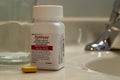 Bottle of Symtuza medication to treat HIV infection in bathroom at home. Chronic illness, modern medicine