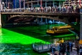 Chicago Water Taxi crosses a dyed green St. Patrick`s Day