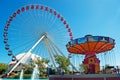 Chicago: wave swinger and Ferris Wheel at Navy Pier on September 22, 2014 Royalty Free Stock Photo