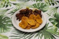 Chicharron De Pollo Con Chuleta Frita Y Tostones