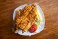 Chicharron de trucha. Traditional Andean recipe in Peru of fried trout served with cassava and salad. Royalty Free Stock Photo