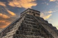 Chichen Itza the famous Mayan pyramid of Mexico under a beautiful orange sky at sunset, belonging to the Mayan culture Royalty Free Stock Photo