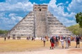 Tourists next to the Pyramid of Kukulkan at Chichen Itza in Mexico