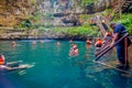 CHICHEN ITZA, MEXICO - NOVEMBER 12, 2017: Unidentified people enjoying the day in the beautiful Ik-Kil Cenote pond with