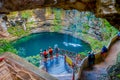 CHICHEN ITZA, MEXICO - NOVEMBER 12, 2017: Unidentified people taking pictures at beautiful Ik-Kil Cenote pond with many