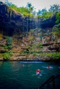 CHICHEN ITZA, MEXICO - NOVEMBER 12, 2017: Unidentified young people swimming in Ik-Kil Cenote near Chichen Itza, Mexico