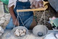 A man is weighing stones at the Chichicastenango market. Royalty Free Stock Photo