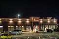 Chick Fil A restaurant at night side view cars and people