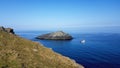 The Chick . The Island off Kelsey HeadKelsey Head is the site of an Iron Age Cliff Castle Royalty Free Stock Photo