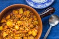 Chick pea, vegetables and meat curry in earthern ware casserole dish Royalty Free Stock Photo