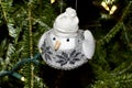 Chickadee holiday ornament in a knit sweater and jaunty cap.