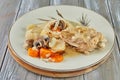 Chicken baked with onions and mushrooms on plate with rice and carrots. French gourmet cuisine Royalty Free Stock Photo