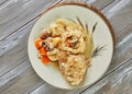 Chicken baked with onions and mushrooms on plate with rice and carrots. French gourmet cuisine Royalty Free Stock Photo