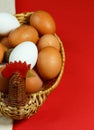 Chicken and a basket with eggs isolated on red background. vertical Royalty Free Stock Photo