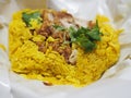 Chicken Biryani food, yellow color Traditional Indian dish of rice and chicken marinated in spices with green sauce Royalty Free Stock Photo