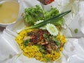 Chicken Biryani food, yellow color Traditional Indian dish of rice and chicken marinated in spices with green sauce Royalty Free Stock Photo