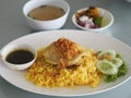 Chicken Biryani food, yellow color Traditional Indian dish of rice and chicken marinated in spices with green sauce Royalty Free Stock Photo