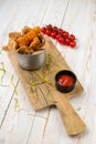 Chicken Breaded Wings In Spicy Sauce With Cherry Tomatoes On Cutting Board, Lunch Menu Of National Food Restaurant On White Wooden