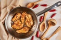 Chicken breast cooking in stainless steel pan