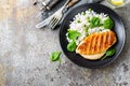 Chicken breast or fillet, poultry meat grilled and boiled white rice with green peas and fresh spinach leaves Royalty Free Stock Photo