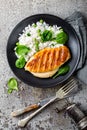 Chicken breast or fillet, poultry meat grilled and boiled white rice with green peas and fresh spinach leaves Royalty Free Stock Photo