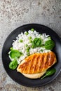 Chicken breast or fillet, poultry meat grilled and boiled white rice with green peas and fresh spinach leaves Royalty Free Stock Photo