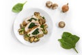 Chicken breast fillet with spinach filling, mushrooms, onion and parsley garnish on a plate, some raw ingredients dispersed on the Royalty Free Stock Photo