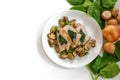 Chicken breast fillet with spinach filling, mushrooms, onion and parsley garnish on a plate, some raw ingredients, white