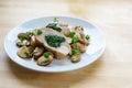 Chicken breast fillet stuffed with spinach, served with mushrooms and parsley garnish on a light wooden table with copy space Royalty Free Stock Photo