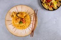 Chicken breast with fried rice on a plate with chopsticks Royalty Free Stock Photo