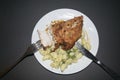 Chicken breast fried with spices, boiled pasta with herbs, a metal fork with a cut piece of breast on a white plate Royalty Free Stock Photo