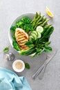 Chicken breast grilled, broccoli with asparagus and fresh green vegetables, spinach leaves in lunch bowl, healthy food, top view Royalty Free Stock Photo