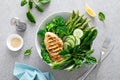 Chicken breast grilled, broccoli with asparagus and fresh green vegetables, spinach leaves in lunch bowl, healthy food, top view Royalty Free Stock Photo