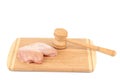 Chicken breast and meat mallet on wooden platter. Royalty Free Stock Photo