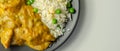 Chicken breast pieces in a mildly spiced coconut curry sauce with fried rice with peas and egg Royalty Free Stock Photo
