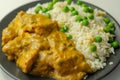 Chicken breast pieces in a mildly spiced coconut curry sauce with fried rice with peas and egg