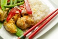 Chicken breast pieces in a Thai red curry sauce made with coconut cream, red chillies, lemongrass, lime leaf, with fragrant rice, Royalty Free Stock Photo