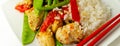 Chicken breast pieces in a Thai red curry sauce made with coconut cream, red chillies, lemongrass, lime leaf, with fragrant rice,