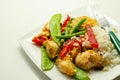 Chicken breast pieces in a Thai red curry sauce made with coconut cream, red chillies, lemongrass, lime leaf, with fragrant rice,