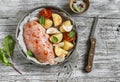 Chicken breast, potatoes, onions, tomatoes - raw ingredients for making baked chicken breast with vegetables